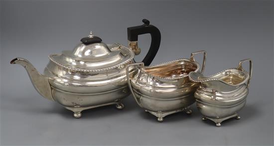 A George V three piece silver teaset, of rounded rectangular form, by Walker and Hall, Sheffield 1934/1935,